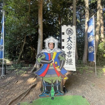 A person behind a samurai figure