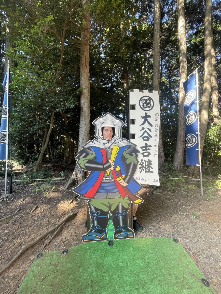 A person behind a samurai figure