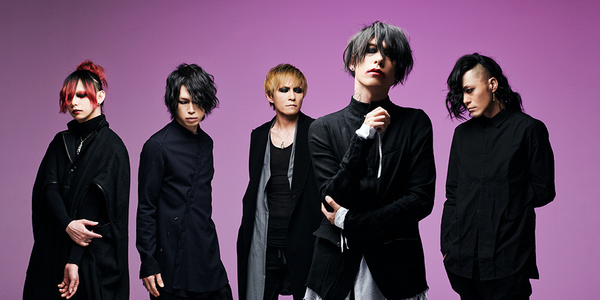 image of popular visual kei band lynch., five men standing against a purple background wearing dark clothing, with styled hair and makeup